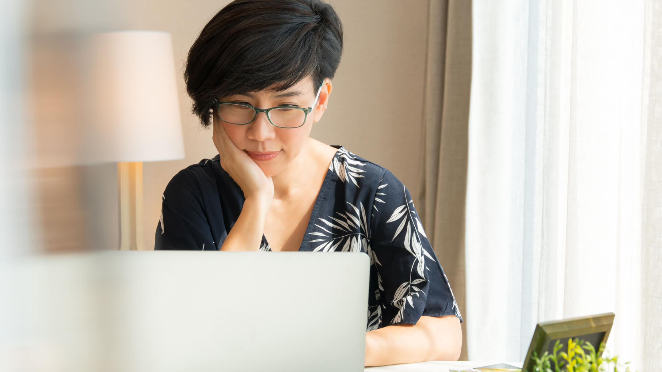 Female patient accessing her medical records on laptop at home