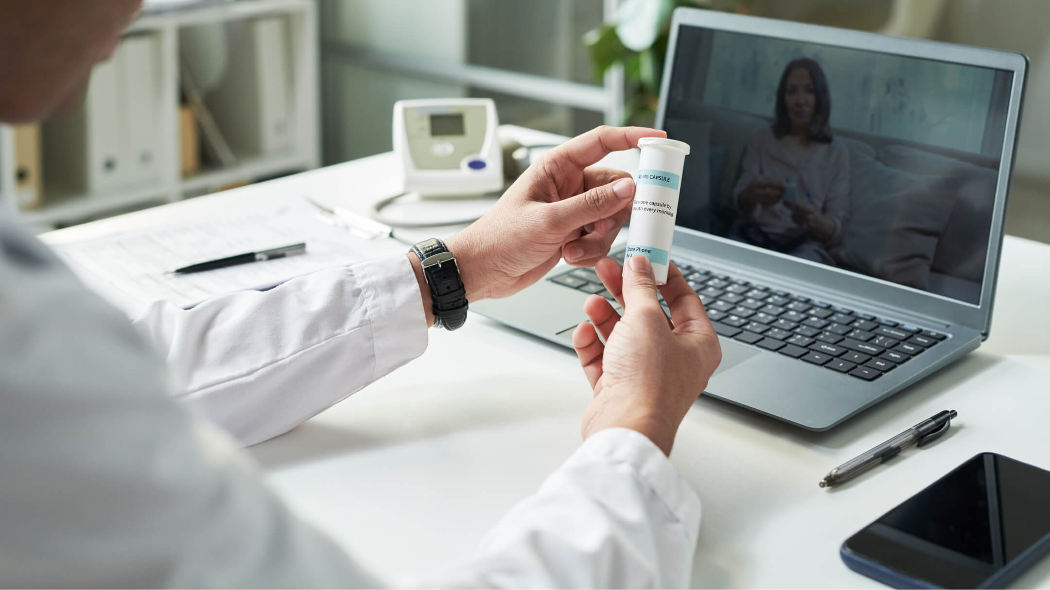 A physician displays a medicine bottle representing real-time prescription benefit solutions.