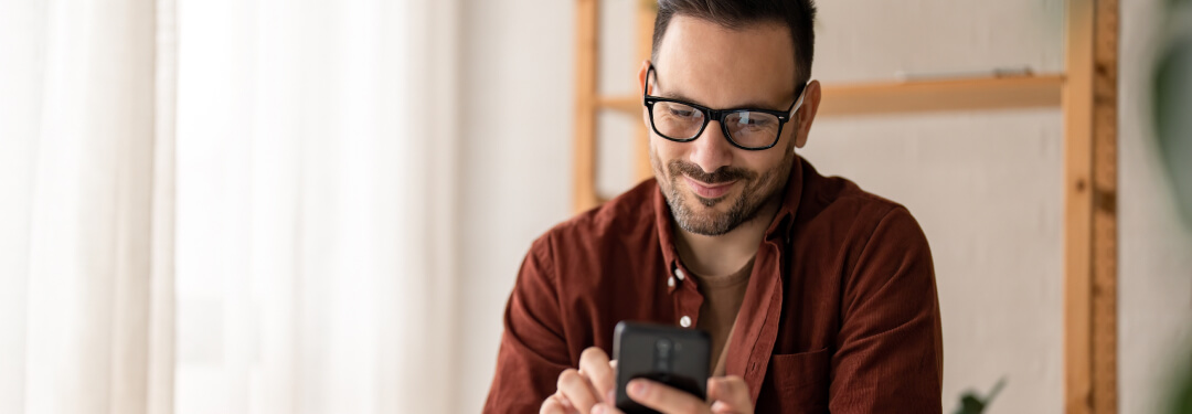 Man at home checking his patient portal, scheduling medical appointments