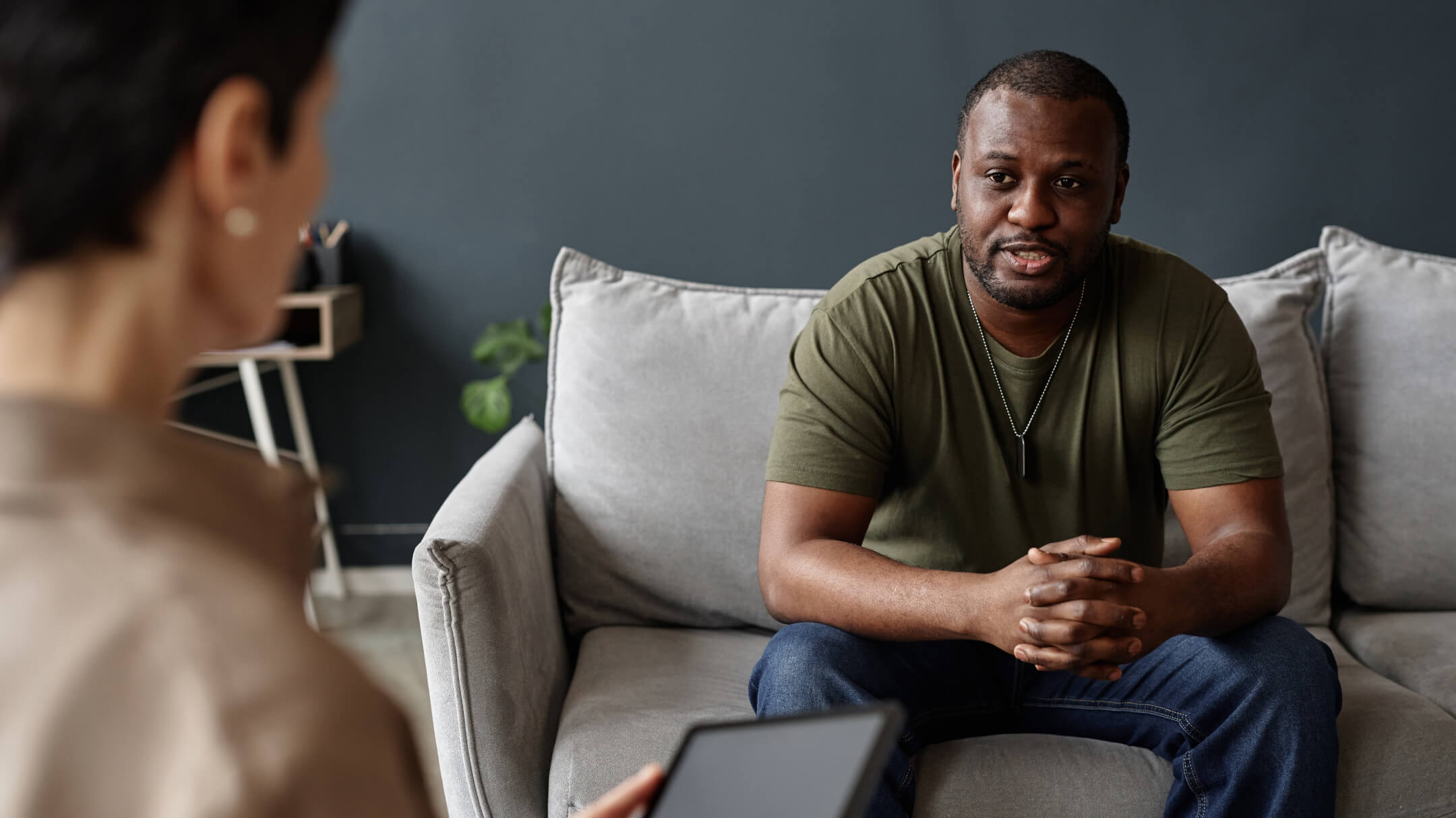 Client consultation at PrimeCare Community Health focusing on data-driven strategies.