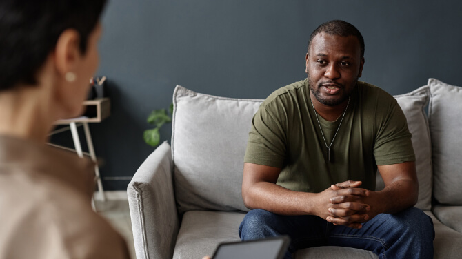 Client consultation at PrimeCare Community Health focusing on data-driven strategies.