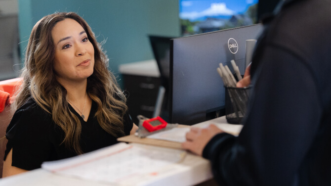  Healthcare professional addressing card on file for improving revenue cycle efficiency.