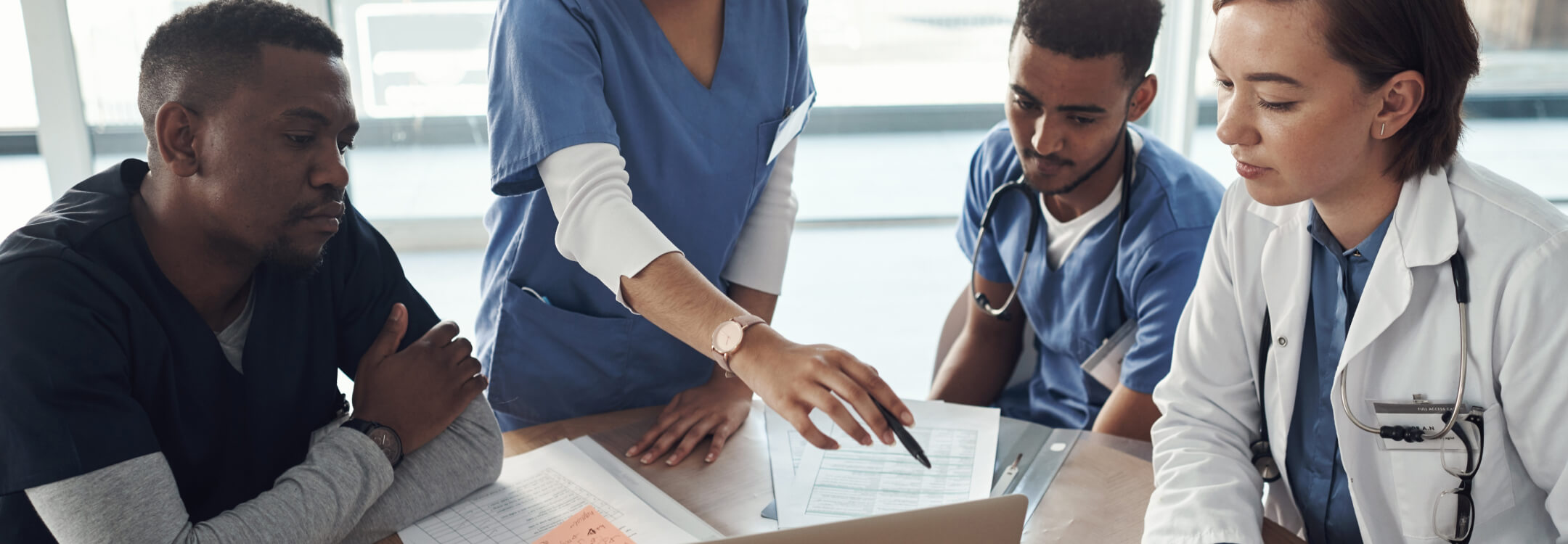 A group of clinicians looking at population health data as part of RHTP funding.
