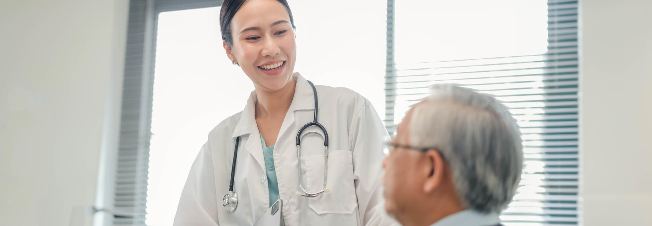 Physician smiling at patient while being treated in medical setting