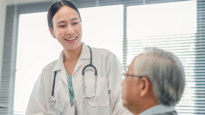 Physician smiling at patient while being treated in medical setting