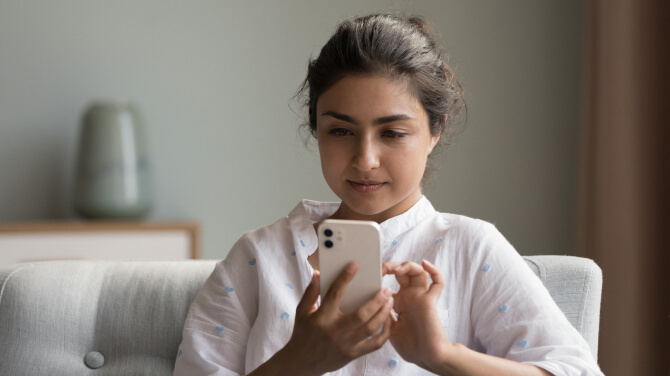A patient focused on her smartphone to explore online reviews for building trust.