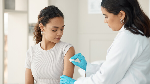 A patient receiving her seasonal vaccines by medical professional