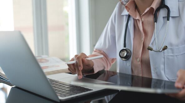 Doctor checking a secure messaging portal for a message from a patient.