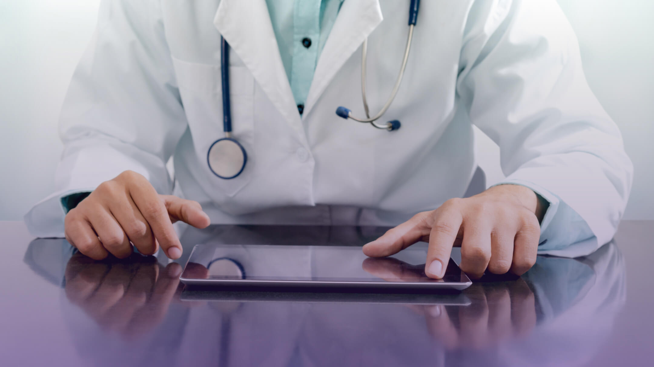 A healthcare professional uses a tablet to access medical data their office.