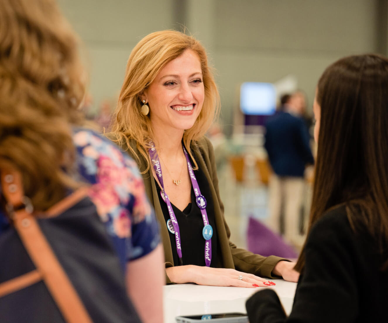 athenahealth staff speaking with attendees at Thrive Demo Booth