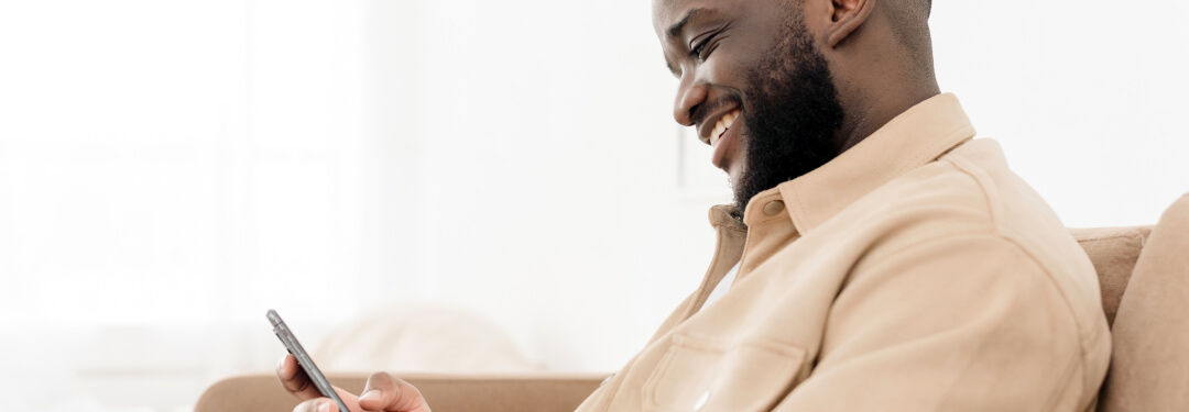 Man smiling after AI agents notified him about an open appointment slot.