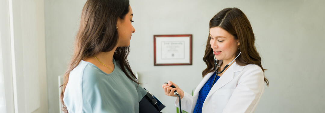 Physician in white coat during exam with a female patient