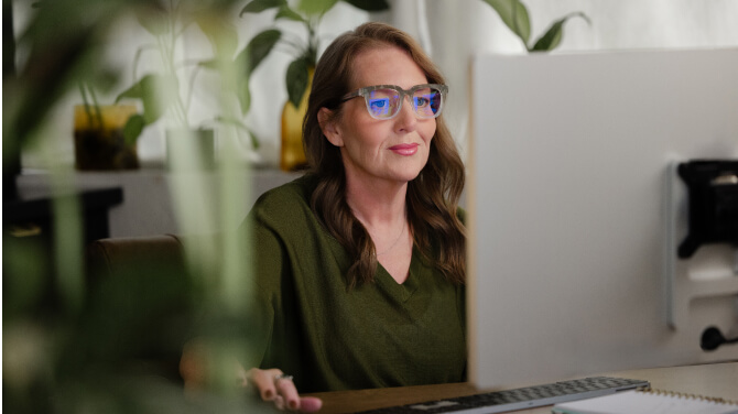 An admin gazes at a computer screen, highlighting the importance of telehealth in modern healthcare.