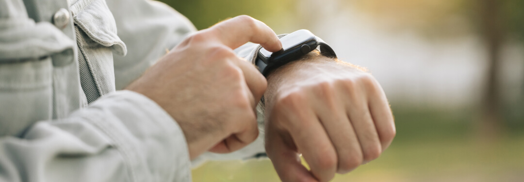 Close view of a parson checking their wearable tech