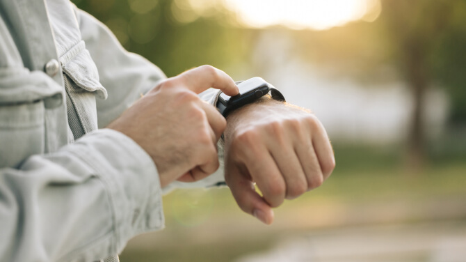 Close view of a parson checking their wearable tech