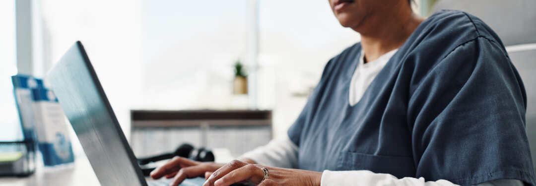 Doctor typing notes to document a patient encounter in the EHR.
