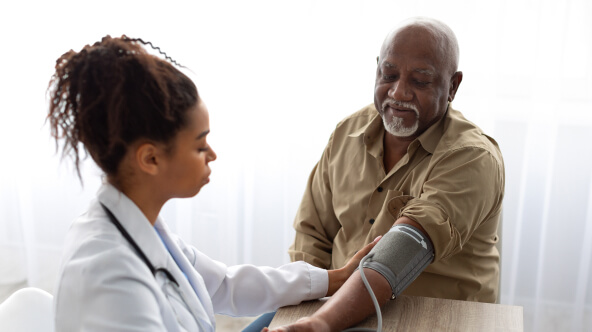 Physician taking blood pressure of medicare patient