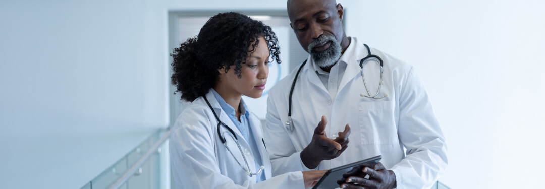 Doctors viewing EHR interoperability integrated within athenaOne.