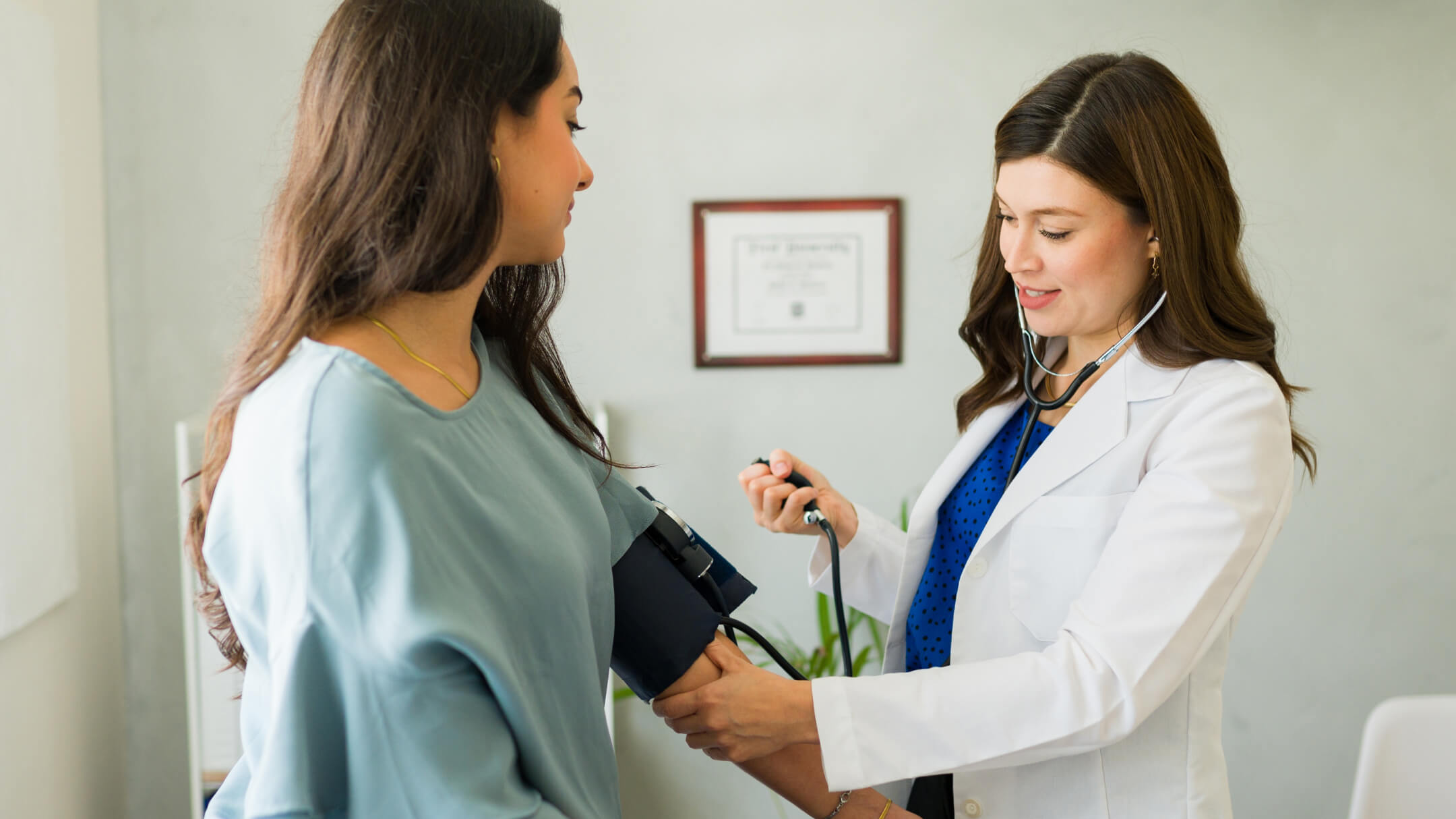 Physician in white coat during exam with a female patient